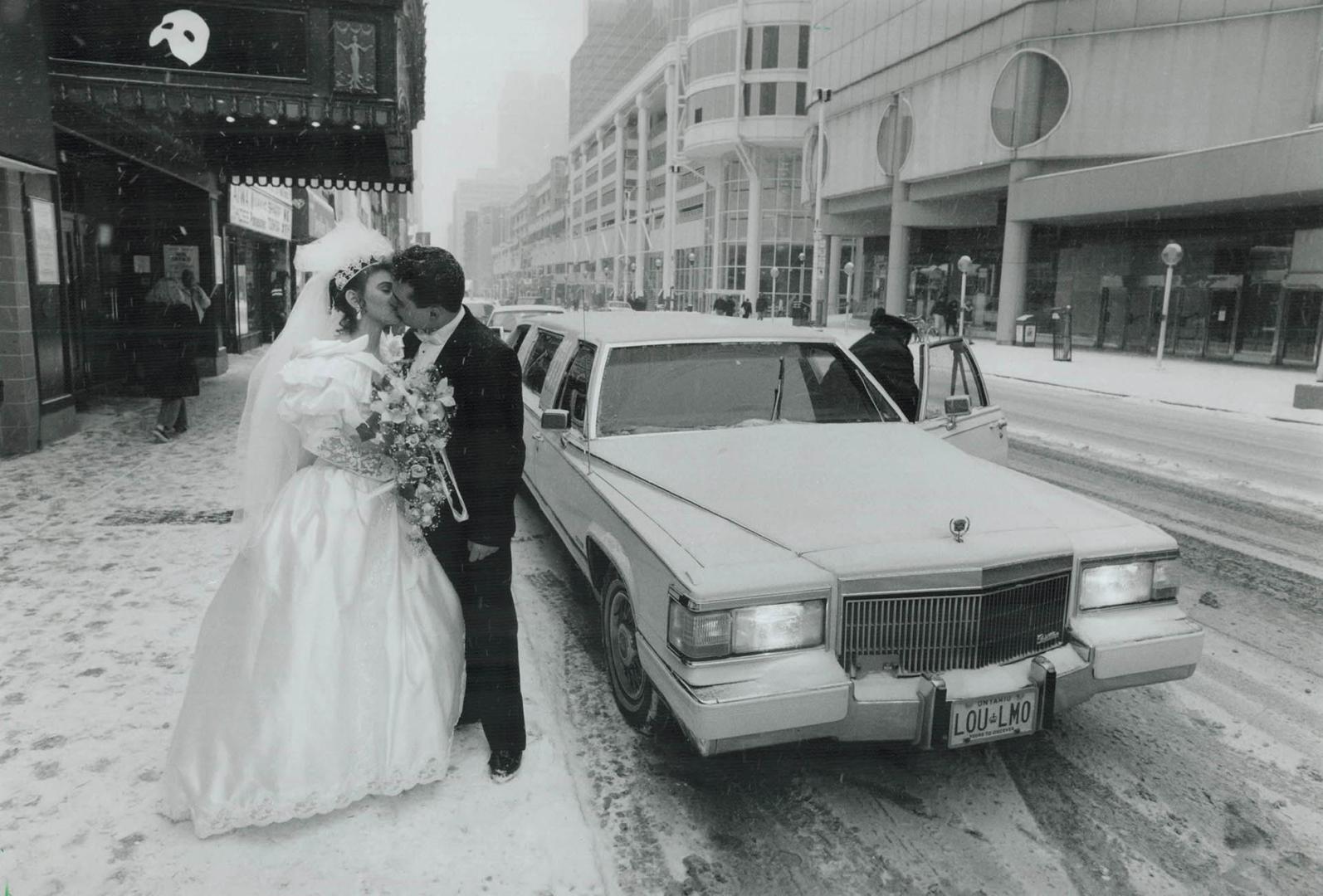 Newlywed fans of the phantom, John, 26, and Anna Mitrothanasis, 23, who were married at noon yesterday, stop on the way to their reception to have the(...)