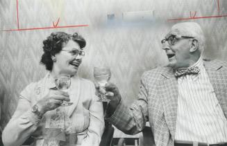 Lillian Brick, 71, and Walter Ottaway, 92, raise their glasses in a toast before their wedding tomorrow at Central Park Lodge