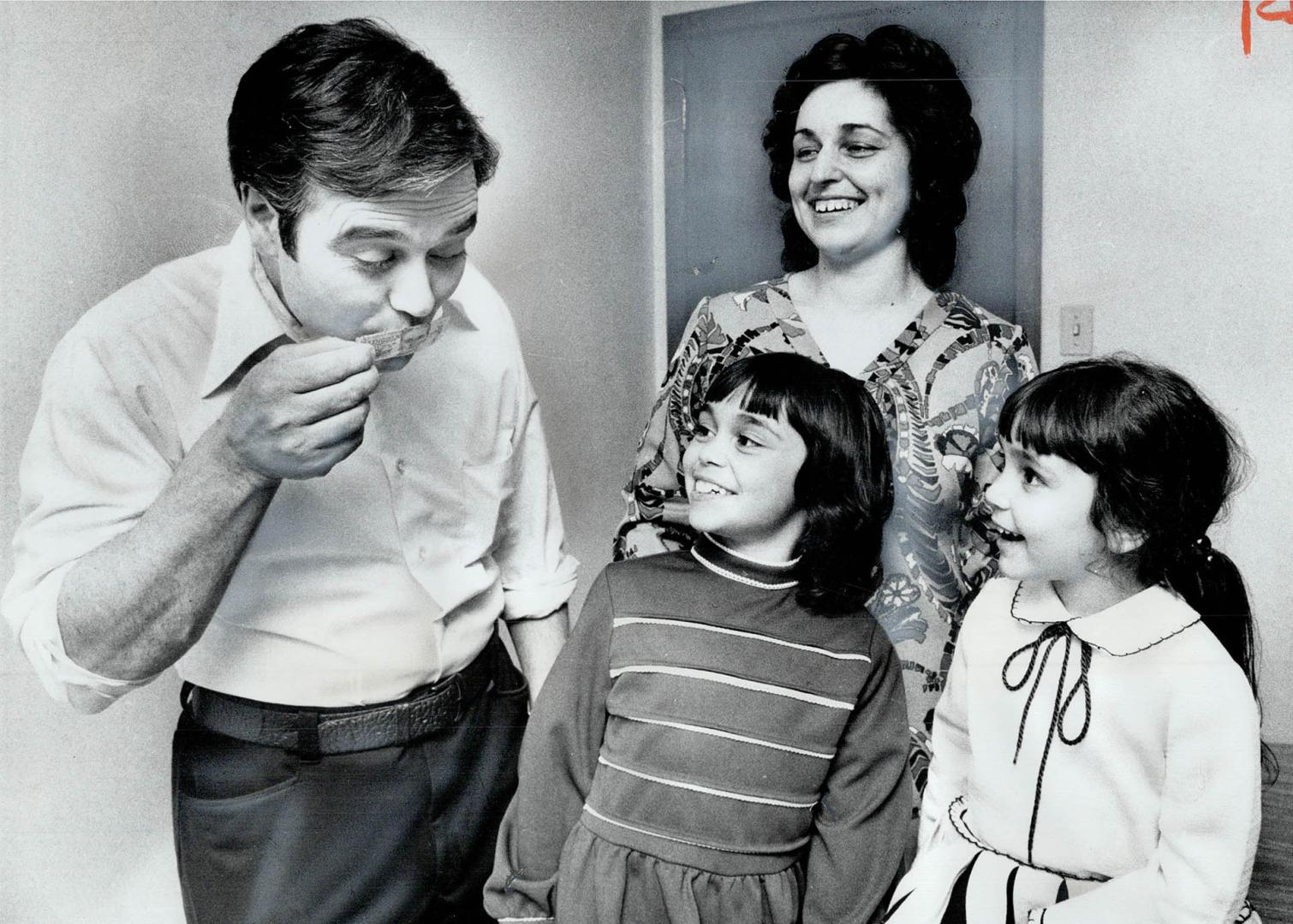 A $115,000 winner in the Irish Sweepstakes, Genesio Porretta kisses the winning ticket while his wife, Concetta, and their daughters, Annamaria, 3, an(...)