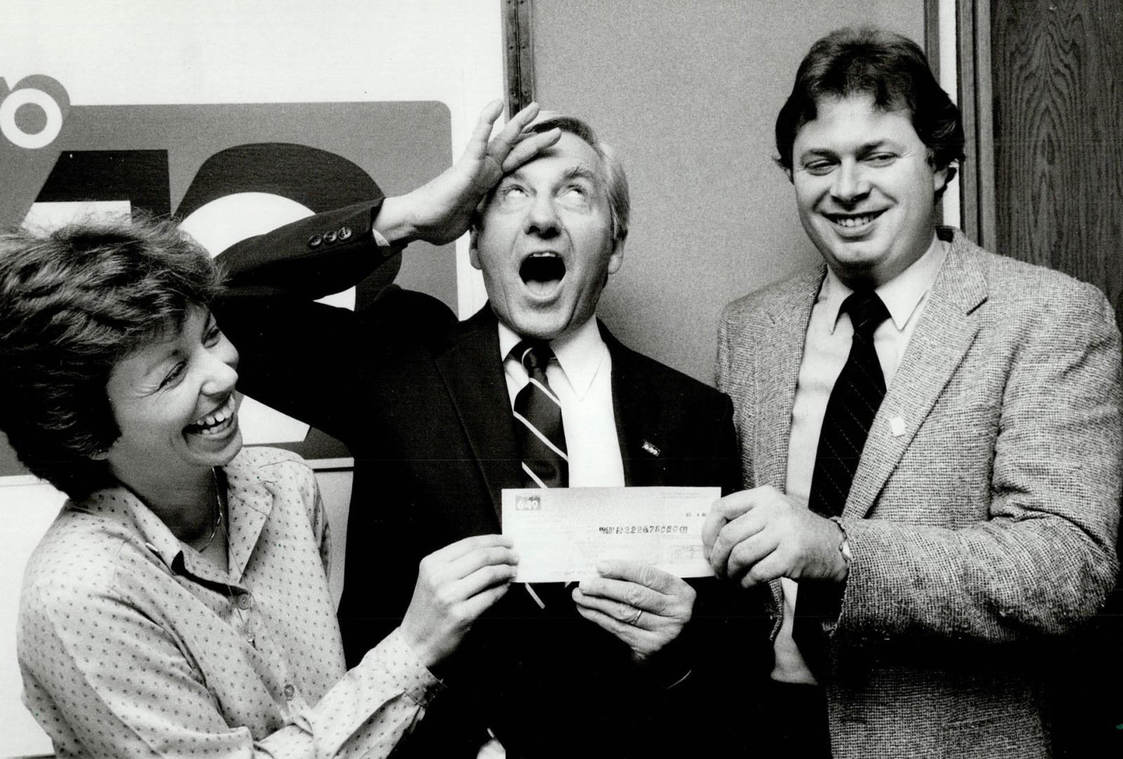 That's a Lotto money! Tourism and Recreation Minister Reuben Baetz, centre, hands over a cheque for $2,226,750