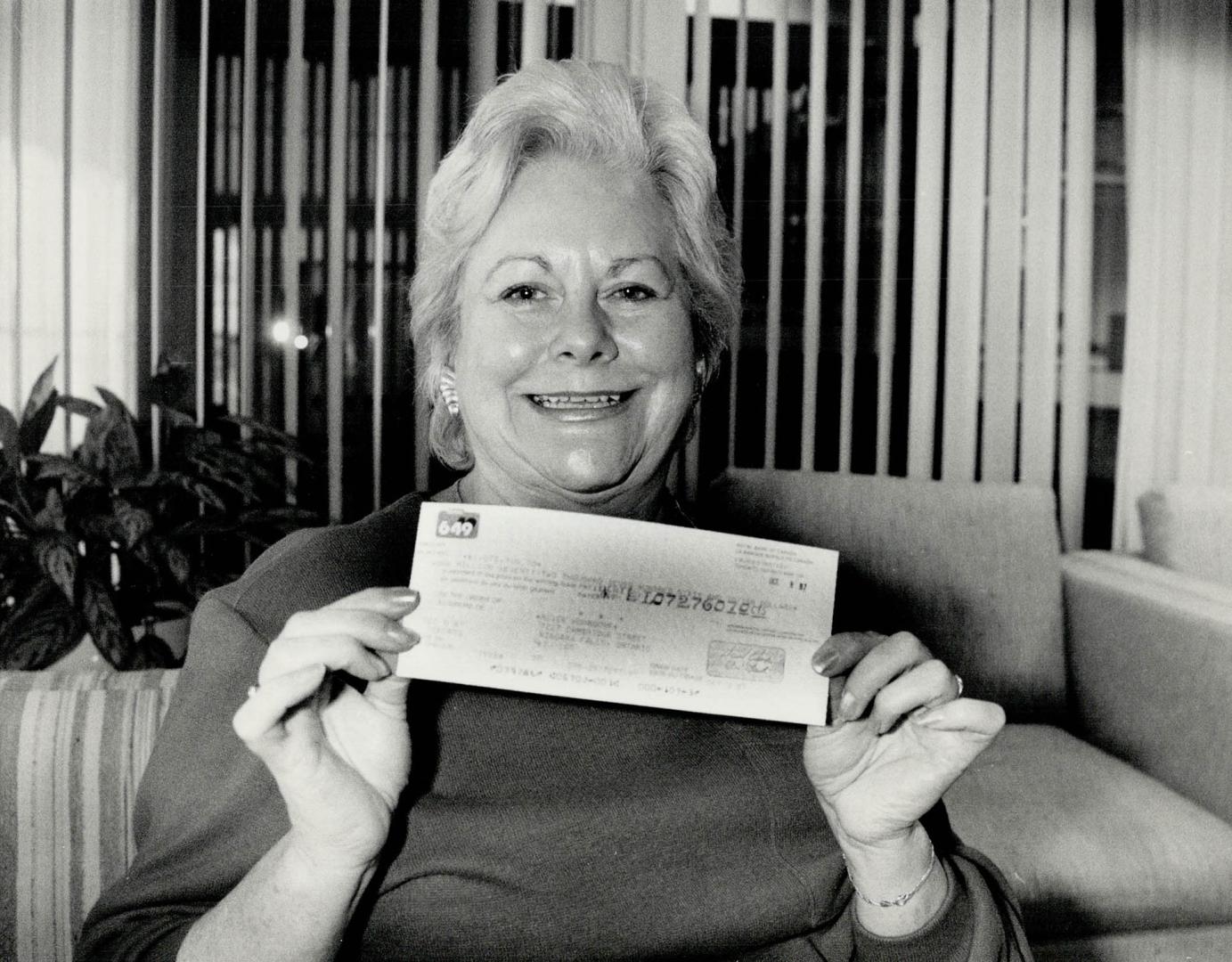 Cheque it out, Marg Huhndorf of Niagara Falls breaks into a winning smile as she shows off the $1