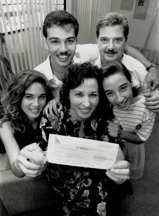 That winning smile, Grace Giustino of Scarborough holds up the cheque for $3,156,987