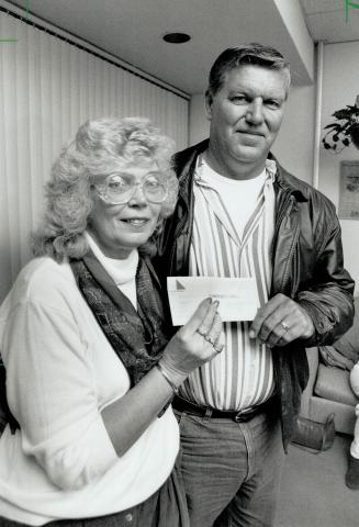 One happy couple: Margaret Boll, 50, and her husband, David Scott, 47, receive the dream of a lifetime ? a cheque for $5 million in Lotto 6/49 winnings