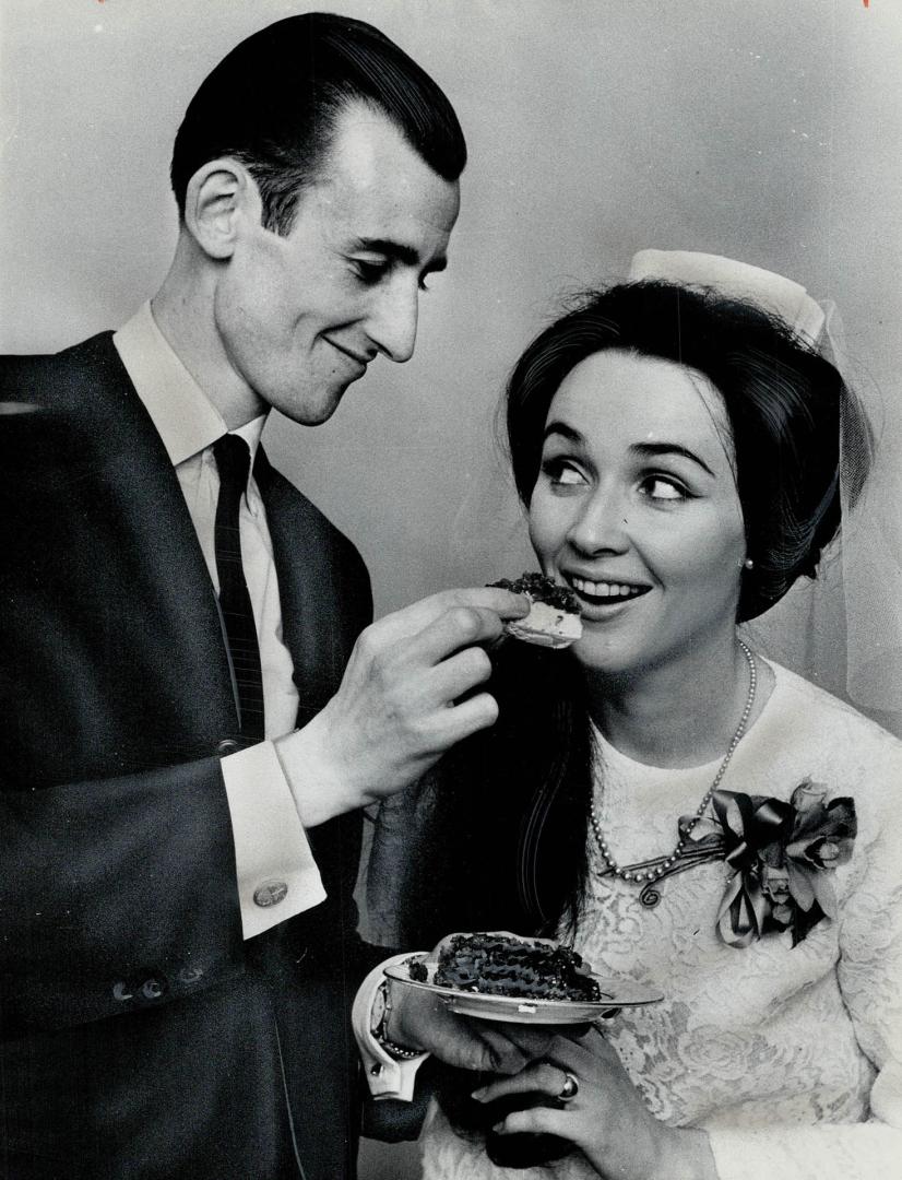 Mark Furness and his bride, the former Barbara Strathdee, who were married at city hall yesterday, sampled their wedding cake at a reception for relat(...)