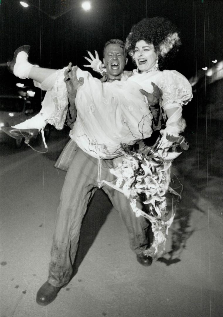 Trick or treat: Allen Roulston hoists his bride-to-be Linda MacLaggen last night in a rehearsal of their off-beat wedding today, features bats in the bouquet