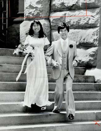 Newly and swiftly wed in a civil ceremony, David Sito, 29, and Irene Kwan, 21, descend the steps of old city hall