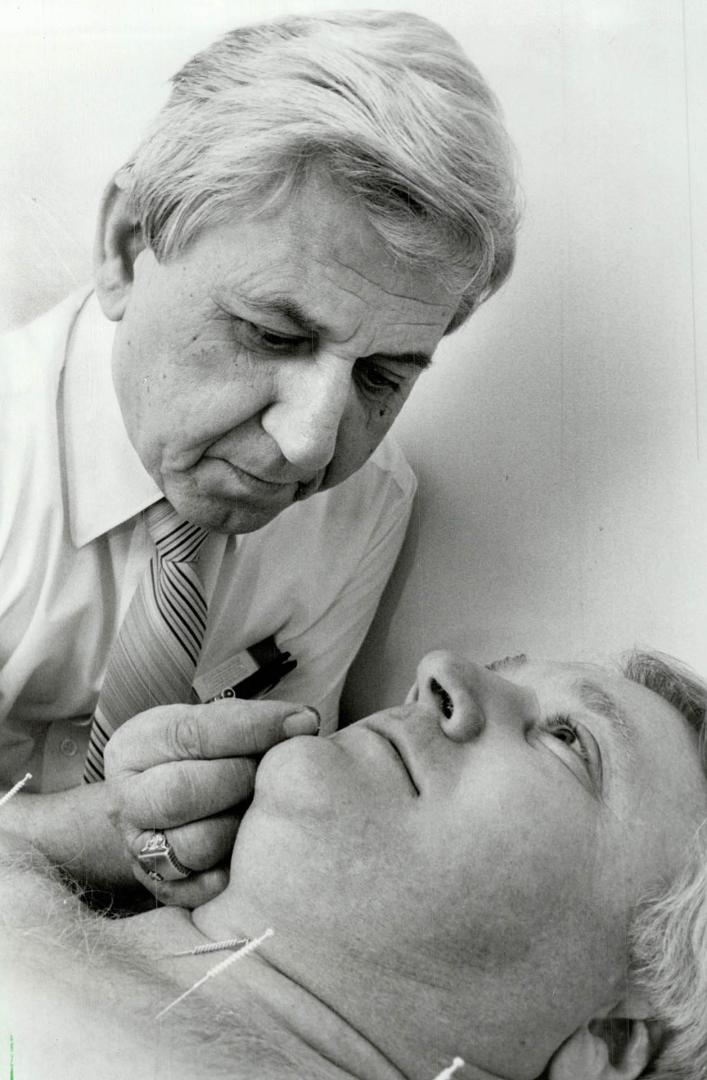 Pain cushion? Leslie Makray sticks silver-coated needles into John Bachly of Toronto at Makray's acupuncture clinic in Kettleby. Acupuncture doesn't c(...)