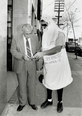 Sage advice, Mr. Condom - also known as Louis Taffo - talks to San Diego Bruno yesterday on St. Clair Ave. W. Taffo, who was handling out condoms and (...)