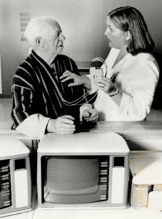 Tuned in: Patient Jake Gold, 84, is shown the operation of a transmitter, sending out heart rate signals, by nurse Sandy Wiesenthal at Baycrest Hospital