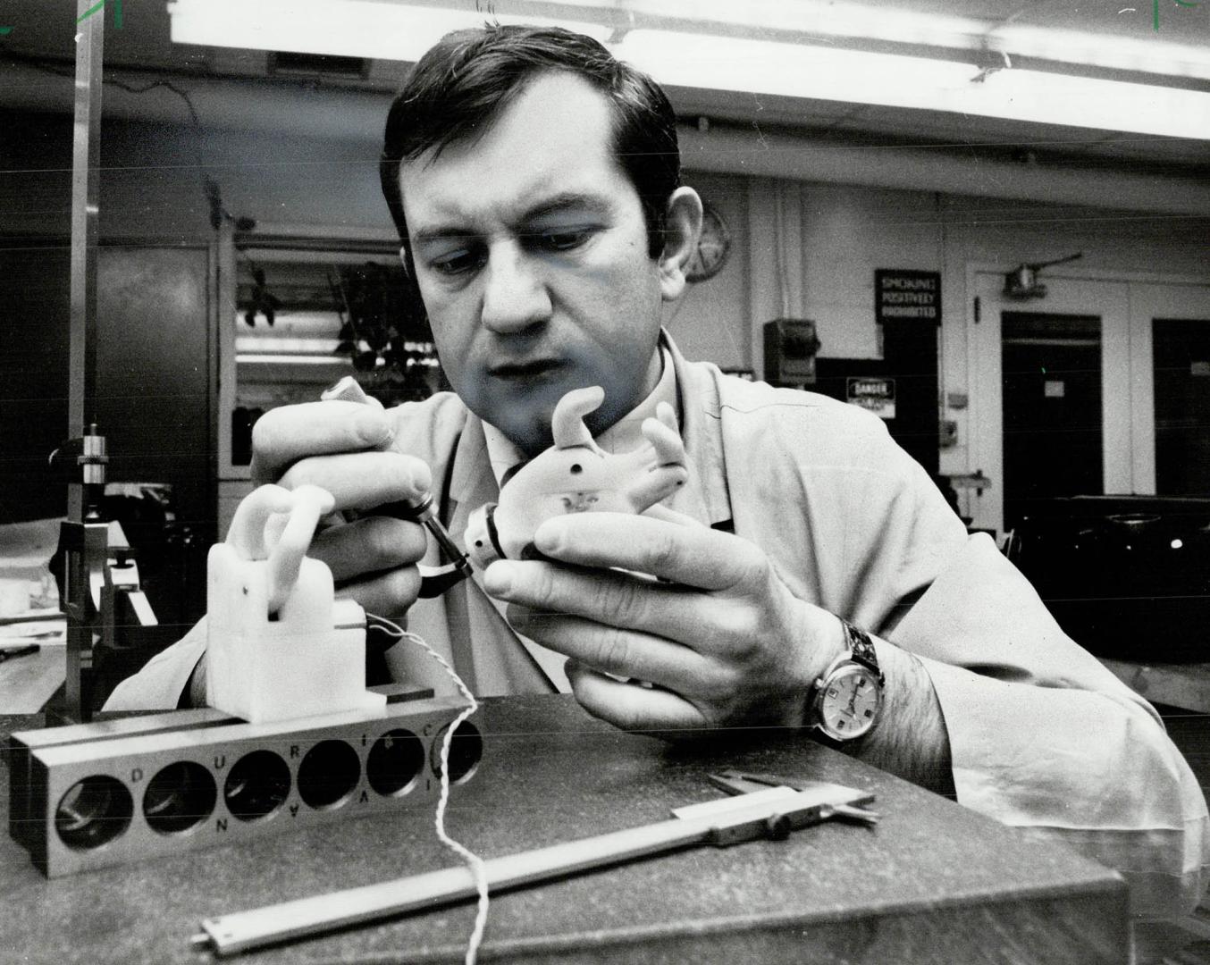 Fine tuning: Dye maker Ivan Duric tinkers with new plastic electrical arm that's almost ready to be tested on humans