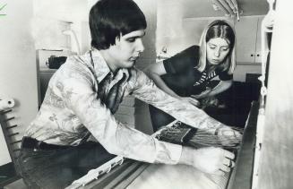 Philip Seabrook works on loom at Ashby House, instructed by Maureen Emerson