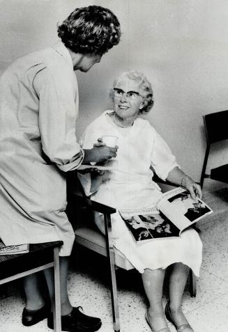 Step one: Volunteer at St. Michael's Hospital breast diagnosis centre brings coffee to a woman about to take the examination for breast cancer