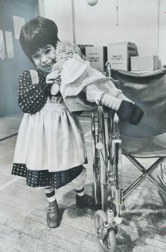 Happiness is a Rag Doll, Dressed like a Raggedy Ann doll, 4-year-old Tanya Gallello hugs the Raggedy Ann given to her at a conference on pediatric car(...)