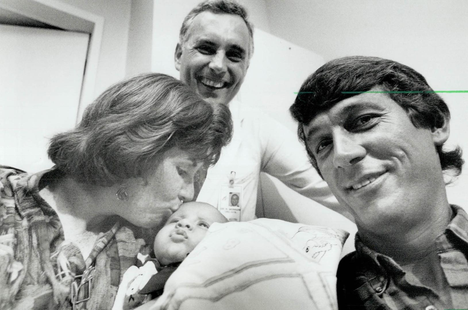 Proud mother: Carol Jilesen kisses her 2-month-old son, Paul, as his successful surgery is announced at Toronto's Mount Sinai hospital yesterday