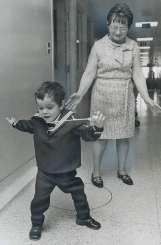 A walking miracle, Kenneth Thurlow, aged 4, takes first unaided steps for grandmother Mrs