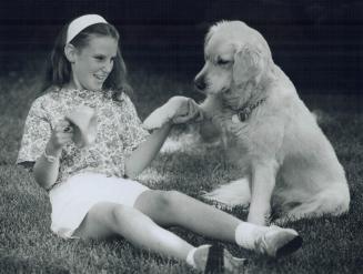 Home Again: Katie Van Dusen, 11, seen playing with her dog Bailey at her Unionville home, was cured of leukemia with a rigorous course of chemotherapy