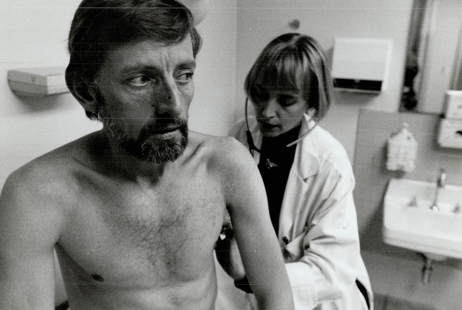 Dr. Elizabeth Tullis examines CF patient John Hoddy