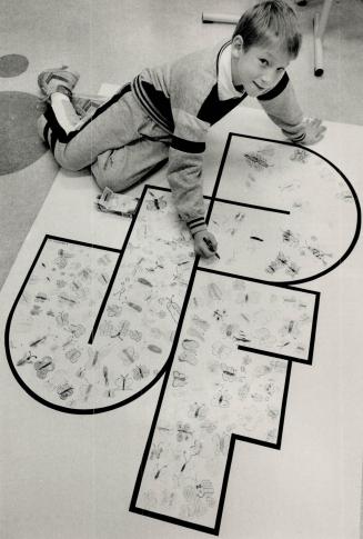 A touch of color, Ian Payne, 9, a Hospital for Sick Children patient, touches up the Juvenile Diabetes Foundation poster, being colored by Toronto-are(...)