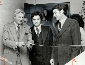 After you, doctor, The ribbon falls away as Premier Bill Davis (left) officially opens the Medical-Dental Financial Credit Union on Sheppard Ave. E. a(...)