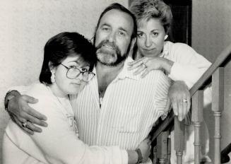 Fighting on: David Irvine, 43, shown with wife Sandi, right, and daughter Mickie, spends his days waiting for a phone call saying a heart is available for the transplant he needs