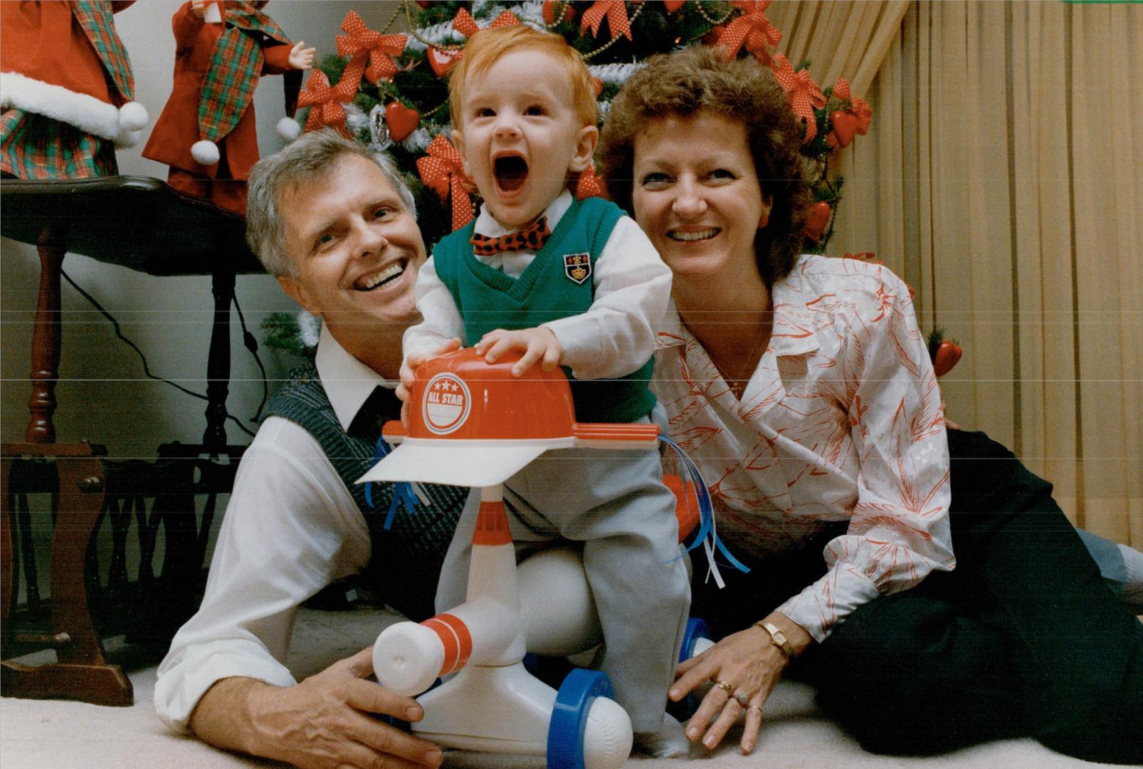 Happy Family: John Kesimaat and Bonnie Hamilton play with 10-month-old Timothy, whose life was saved by a heart transplant last April