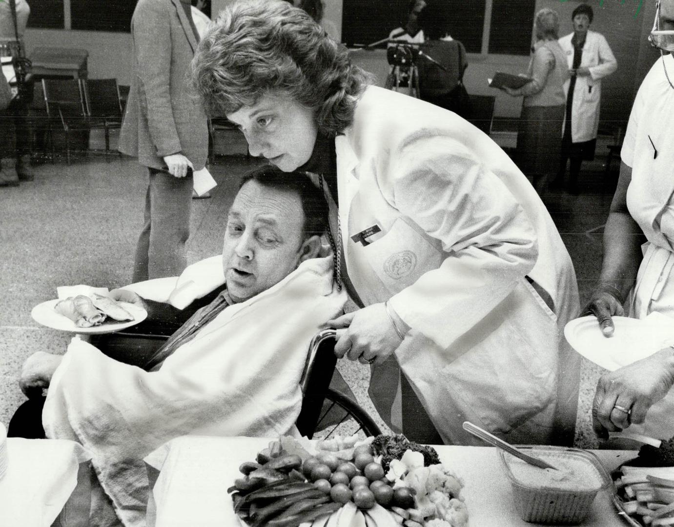 Hospital reunion: A nurse wheels heart transplant patient Ted Younger by the buffet table as he and five other transplant patients celebrated at a reunion yesterday