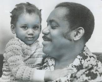 Awaiting a kidney transplant, police inspector Arnim Mondesir of Trinidad smiles at his daughter Charmaine, 20 months, in the Metro home of a relative(...)