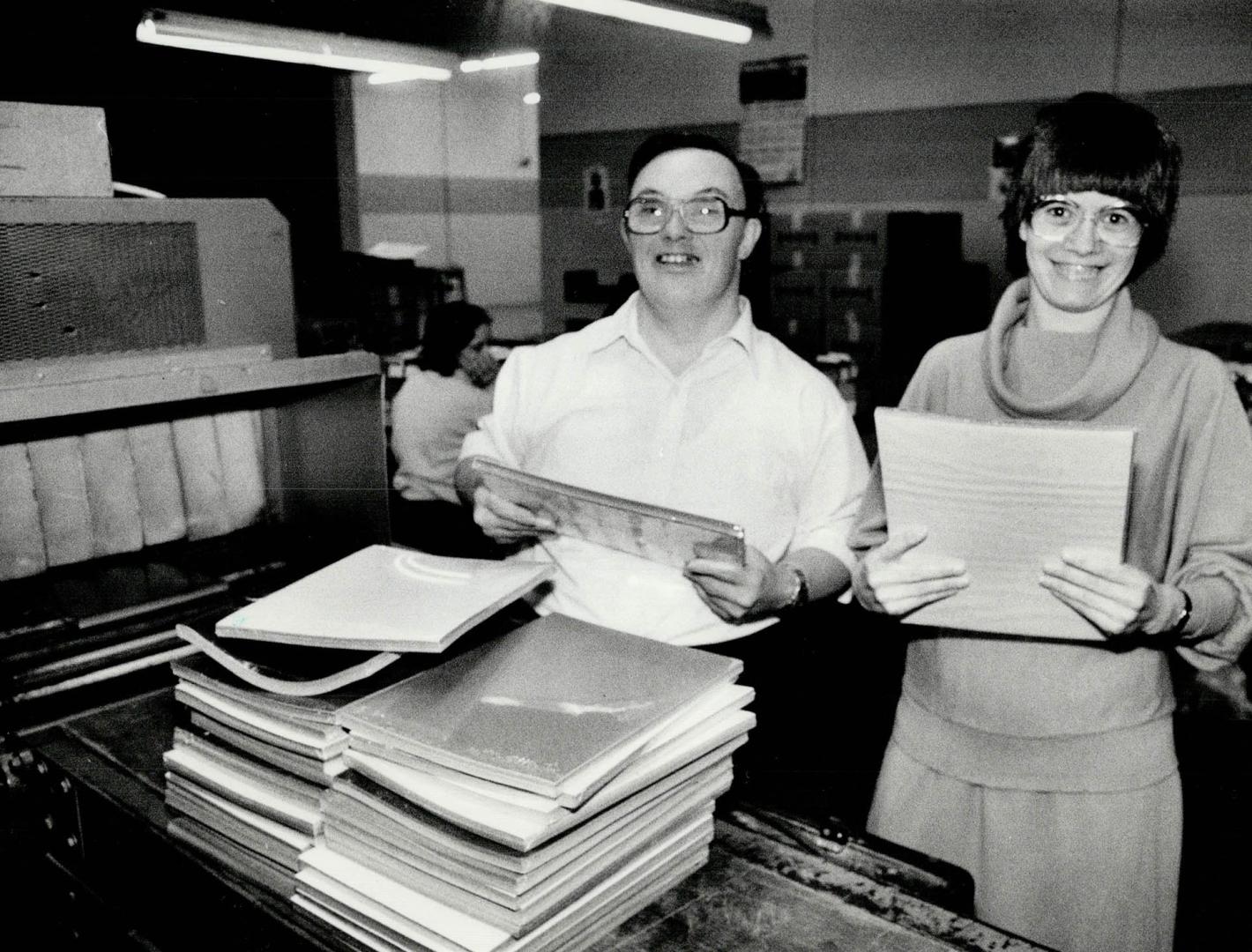 New workplace: Mary Mastromatteo and Crawford Noble, employees of Central ARC Industries, stack paper into shrinking tunnels at their new workplace in Scarborough