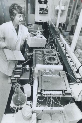 Doris Skeats checks automated equipment at the province's central lab in Etobicoke