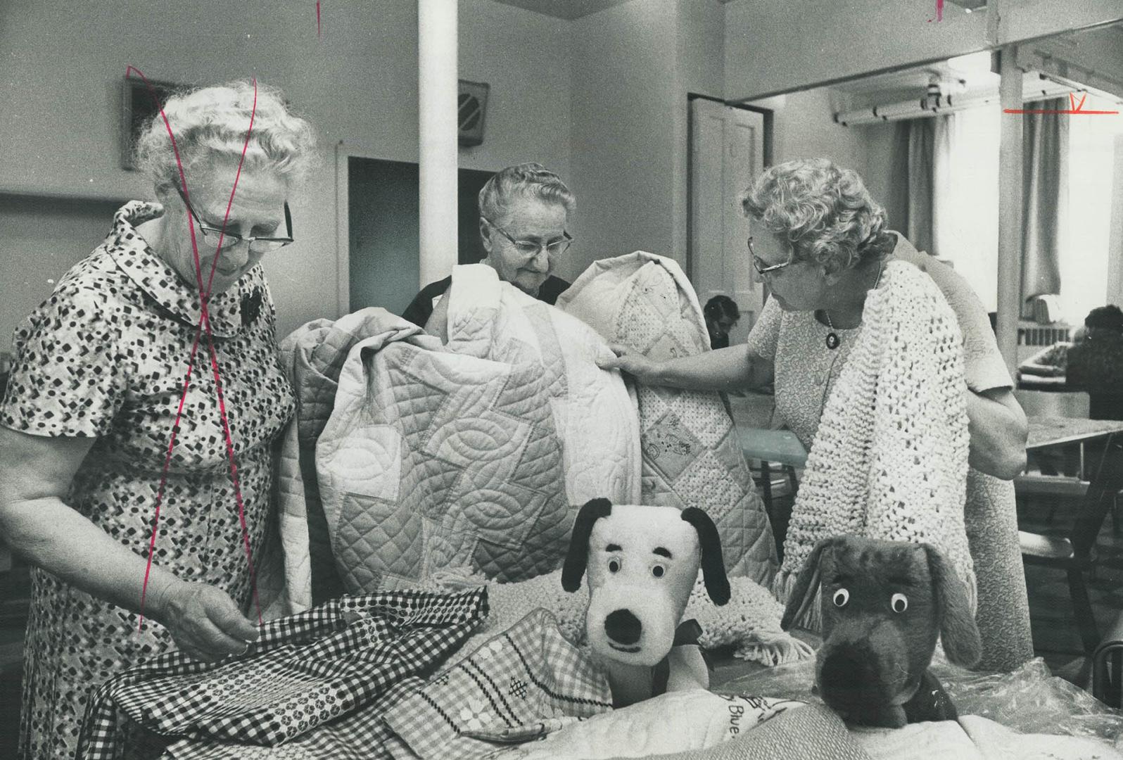 Hand-Made Quilts, for sale are one of the highlights of the Mennonite Relief Sale to be held this Saturday at New Hamburg. Here Mrs. Abraham Dick and (...)