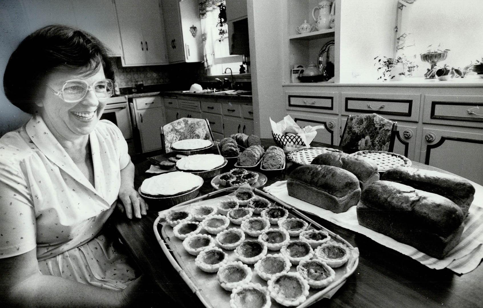 Homemade goodies: At left, Mabel Sauder shows off a tray of fresh tarts which will be on sale Saturday, and above Helen Duerrstein holds a wall hanging