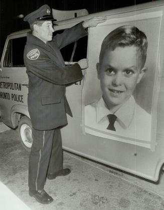 The mobile view of Wesley Watson, PC Vincent Freer mounts portrait on sound truck