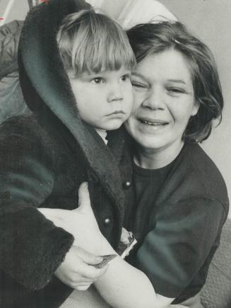 The object of a search by 250 policemen and volunteers, 3-year-old John Hachey clutches his mother, Shirley Hachey, after he was found in a restaurant(...)