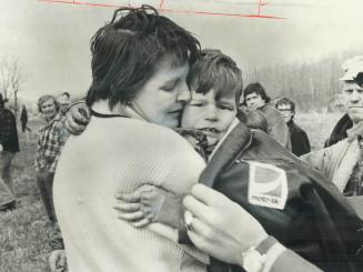 Robert Johnson, 4, is hugged by his mother, Carol Johnson, after he was found yesterday lying in a small hollow after being lost for 30 hours in dense(...)