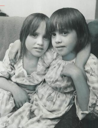 Safe at home after sleeping outdoors Sunday night in freezing weather, Kimberly Pinkerton, 9 (left), and her sister, Patricia, 7, are ready for bed la(...)