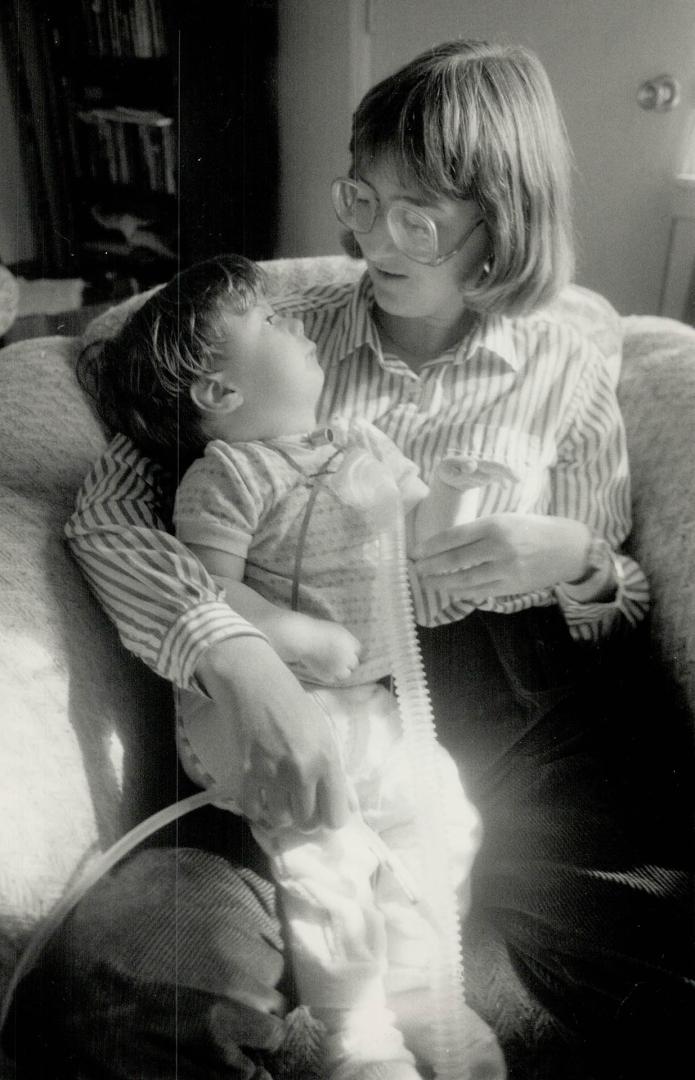 Sharon Manchee, one of three Scarborough health department nurses who visit babies and toddlers recovering from serious illnesses in their homes, visits with Rosemary Power, 2