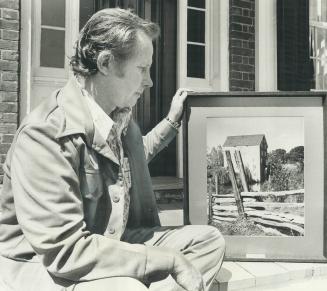 Camera study of old mill, held by photographer Bill Lowry, is one of his series of pictures of pioneer Canada as it lives today, currently on exhibiti(...)