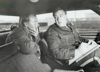 Above, from left, OPP Constables Hugh Croney, Cam Woolley, Andy Gibaut (shown talking to a driver) and Steve Robertson patrol the 401