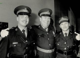 All in family: A proud Sergeant John Richardson welcomes his son John, 22, and daughter Kimberly, 20, into the OPP after the two graduated from the same class