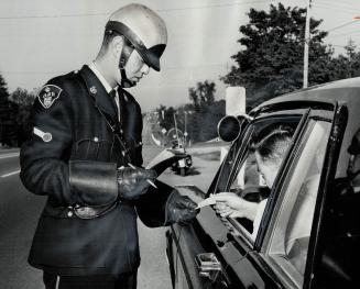 Constable Ken Smith gives Motorist a ticket, Police use T-shaped markings at roadside in timing drivers from air