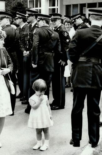 Miss apprehension, Tracie Tomalak, 2- year-old niece of Daryl Knox of the Ontario Provincial Police detachment at Whitby, seems a little detached hers(...)