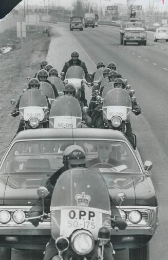 Police on parade, A police car cruising along the Queen Elizabeth Way in Oakville gets a special police escort