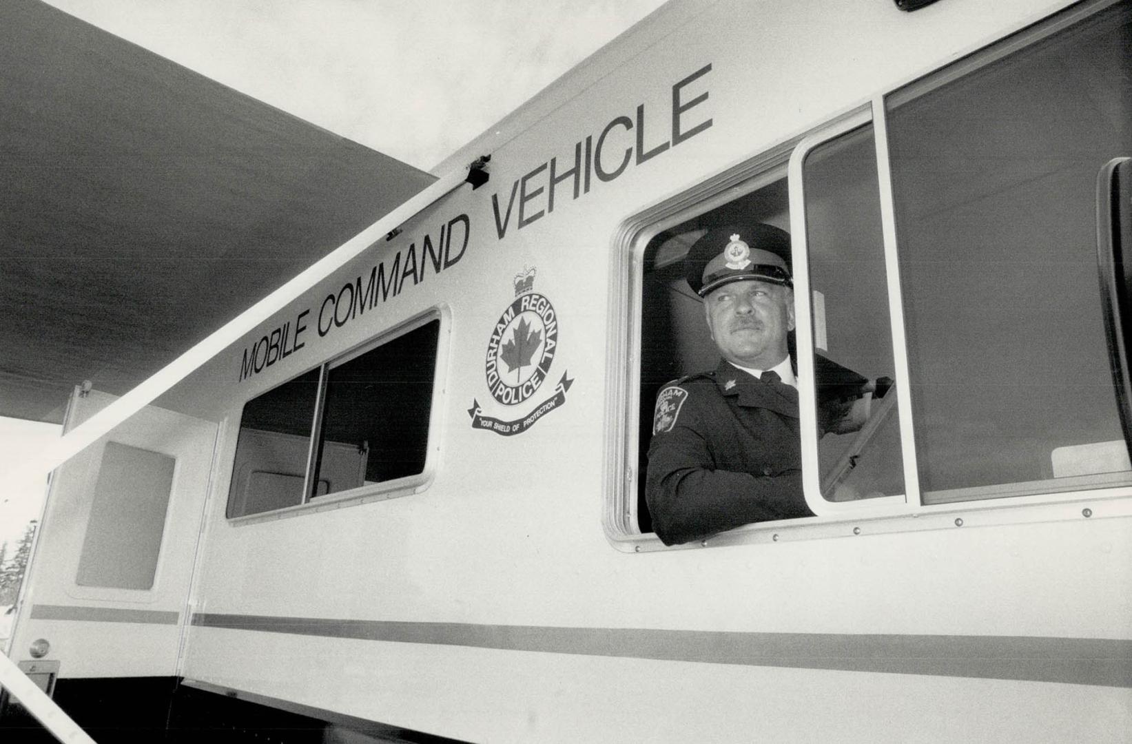 On the road again: Inspector Bob Brown proudly shows off the Durham Regional Police force's new $90,000 mobile command vehicle equipped to be a communication centre in emergencies