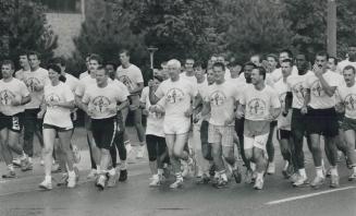 Pounding the police beat, Members of Halton Regional Police carried the torch along Lakeshore Rd