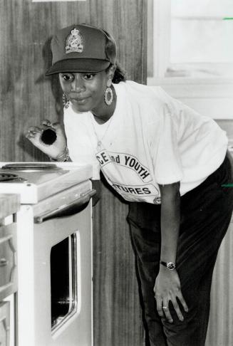 Dusting for clues: Carleene Burrell of Oakville takes fingerprints from a stove top at a crime scene, part of a two-day crash course in basic training