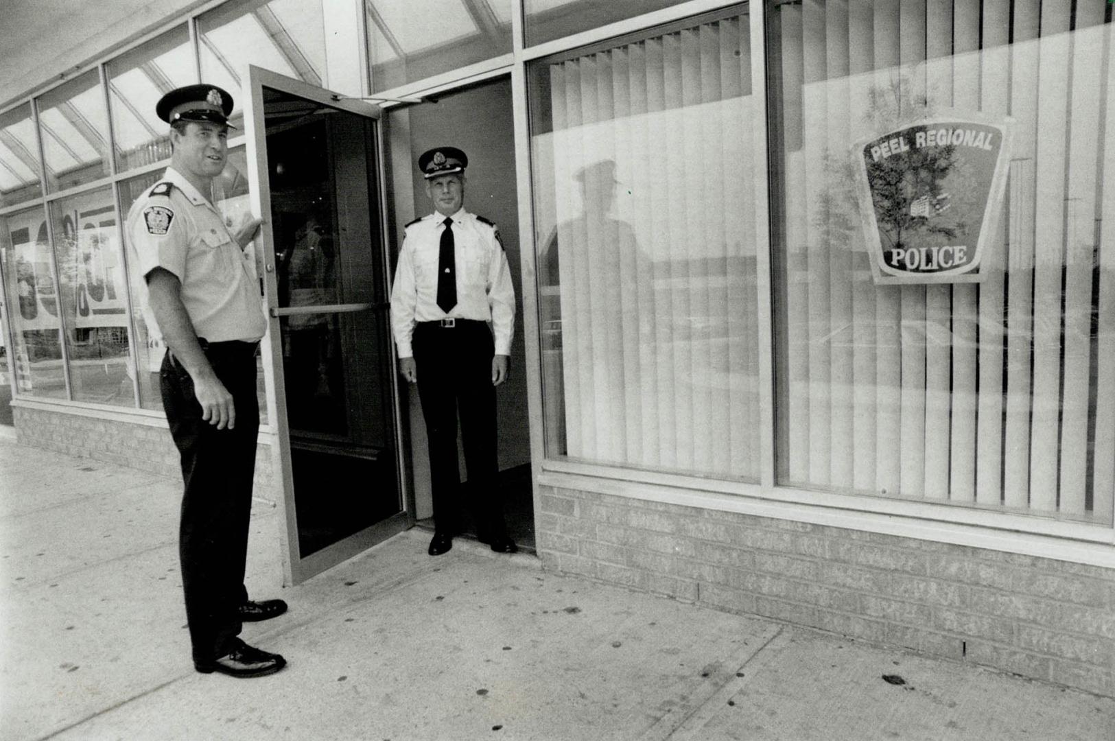 Staff Sergeant Bernie Swain and Inspector Ewen MacDonald have the welcome sign out at Peel Regional Police's new community office in the Heart Lake To(...)