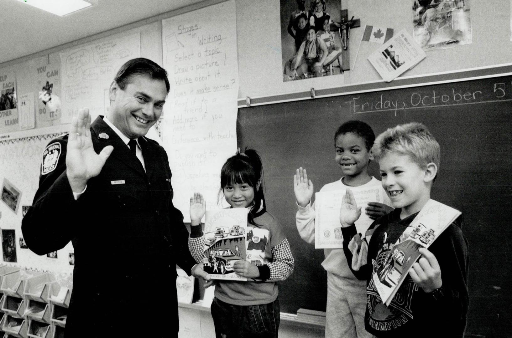 Swearing In, Peel Regional Deputy Police Chief James Bertram swears in Jocelyn Alemania, Raymond Levy, and Tyler Lajoie, of St. Kevin School in Brampt(...)