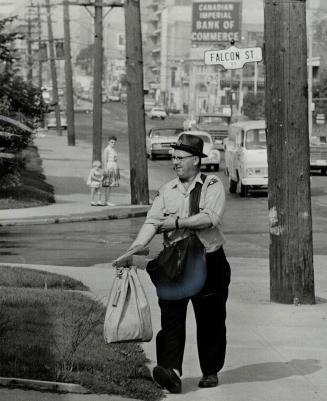 Carrying 3-week-old letters, but being greeted like a long-lost friend by everyone on his route, Orvin Millett, postman, was back on the job yesterday(...)