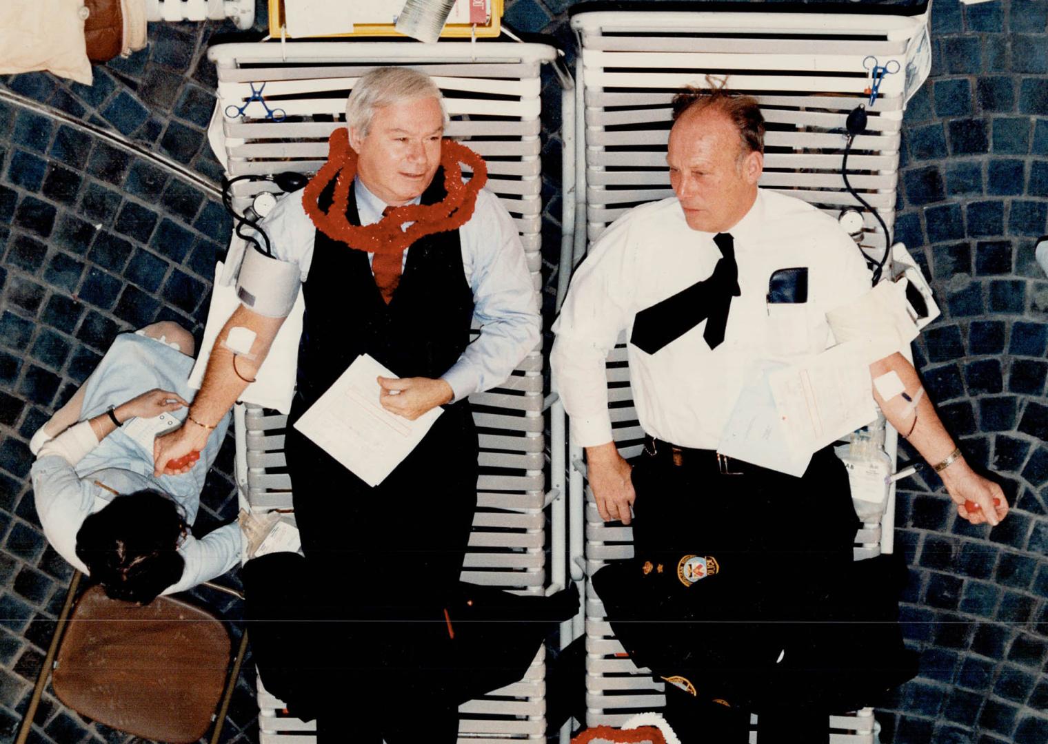 Mayor's blood donor clinic goes Hawaiian, Metro police Staff Superintendent Mike Coulis (left) and Scarborough Controller Frank Faubert got a chance t(...)