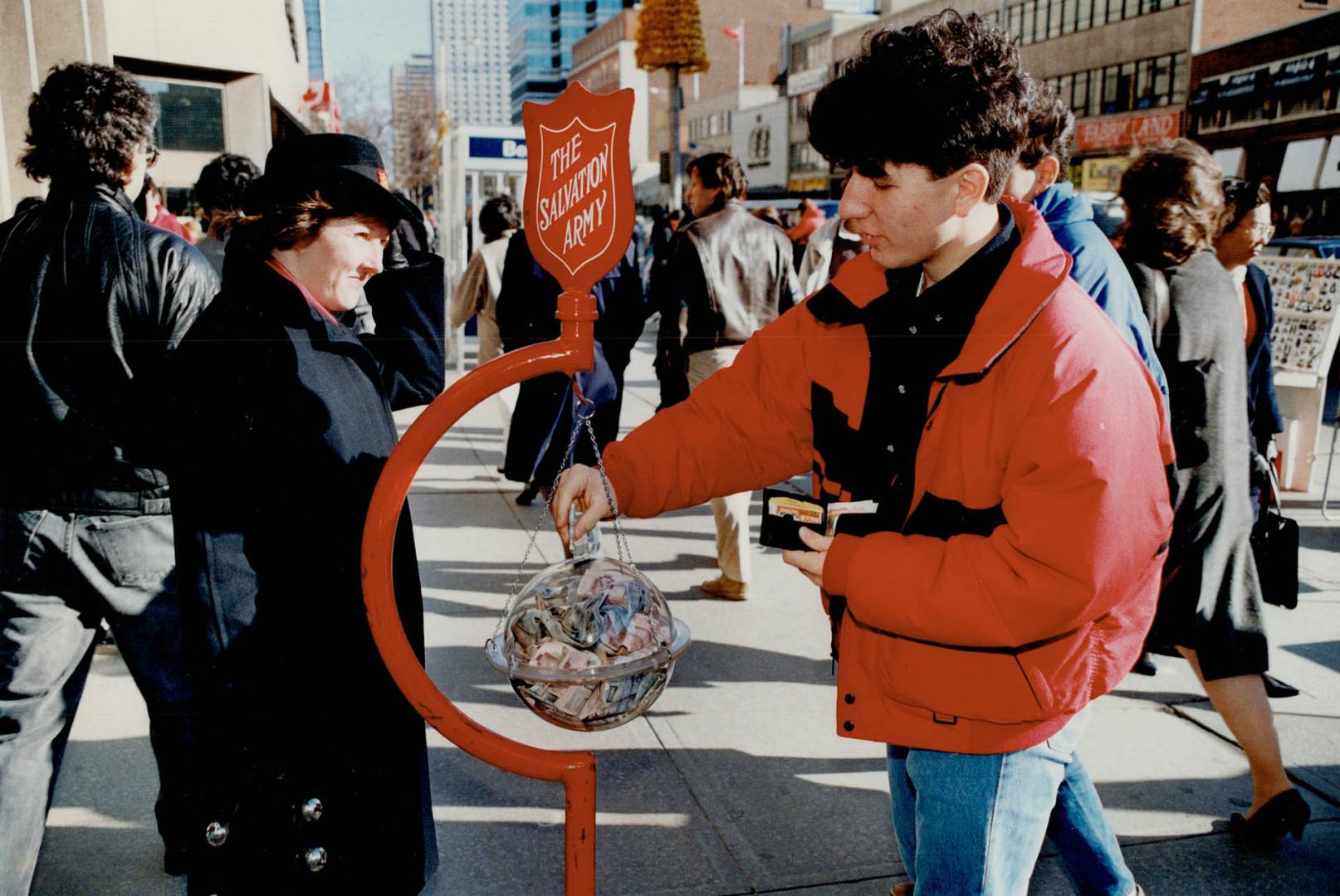 They give and give - to the tune of more than $300,000 a year - at the Salvation Army kettles around Metro staffed by cadets like Dale Lewis, middle, and Mark Guyler